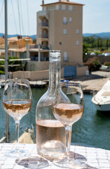 Glasses of cold rose gris Cote de Provence wine in yacht harbour of Port Grimaud, summer vacation on French Riviera in Provence, France