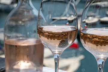 Glasses of cold rose gris Cote de Provence wine in yacht harbour of Port Grimaud, summer vacation on French Riviera in Provence, France