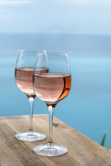 Summer time in Provence, two glasses of cold rose wine with blue sea view on background, French Riviera near Menton, south of France