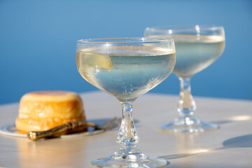 Cold sparkling wine, cava or champagne in two coupe glasses on table with blue sea water view, French Riviera is summer, France