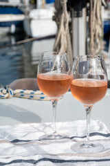 Party with rose wine on yacht boat anchored in port la Rague, Gulf of La Napoule, in Provence, two glasses of cold rose wine, French Riviera near Cannes, south of France