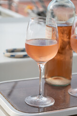 Party with rose wine on yacht boat anchored in port la Rague, Gulf of La Napoule, in Provence, two glasses of cold rose wine, French Riviera near Cannes, south of France