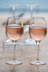 Summer time in Provence, two glasses of cold rose wine with blue sea view on background, French Riviera near Menton, south of France