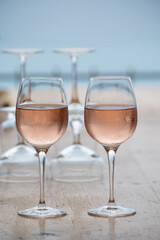 Summer time in Provence, two glasses of cold rose wine with blue sea view on background, French Riviera near Menton, south of France