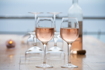 Summer time in Provence, two glasses of cold rose wine with blue sea view on background, French Riviera near Menton, south of France
