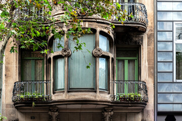 Large alcove window with two balconies on both sides against a beige wall. From the Windows of the World series.