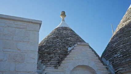 A close-up view of traditional trulli houses in alberobello, italy, showcasing their unique conical...