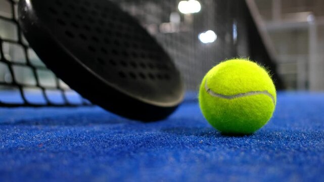 Paddle tennis rackets and balls in court