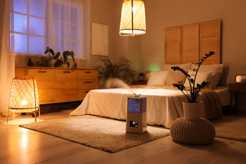Modern air humidifier on floor in dark bedroom