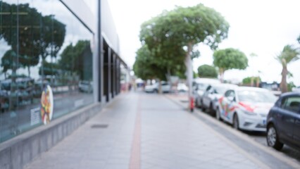 Blurred view of a street with cars and trees in lanzarote, spain, showcasing an urban outdoor scene with a defocused background and bokeh effects