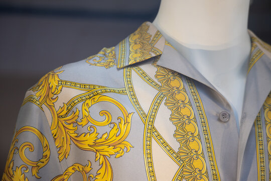 Milan, Italy - August 20, 2024: A close-up of a Versace shirt in a boutique window on Milan's famous shopping street Montenapoleone
