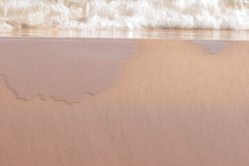 Lake Michigan gently washes over the small incline created in the beach sand, under the November sun within Kohler-Andrae State Park, Sheboygan, Wisconsin