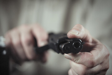 Man take care of semi automatic pistol handgun at home