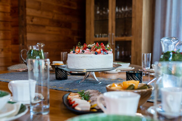 Indoor Dining Table with Elegant Cake and Assorted Dishes