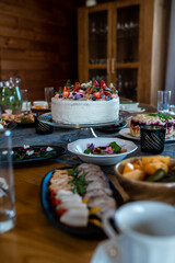 Indoor Dining Table with Festive Meal and Decorated Cake