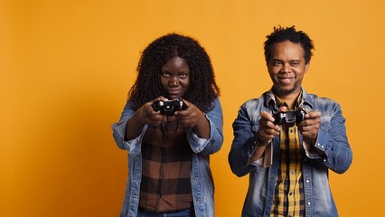 African american man beating his wife at video games tournament online on console, feeling cheerful...