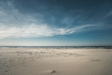A beautiful sandy beach featuring the ocean in the distant background