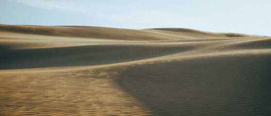 Stunning sand dunes in the desert with a clear blue sky