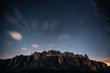 A beautiful starry night sky with a majestic mountain in the foreground