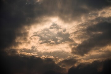 Golden sunlight through stormy clouds