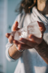 close up of a person holding a glass 