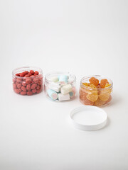Collection of three gummy jelly colourful jars of different sizes on transparent background