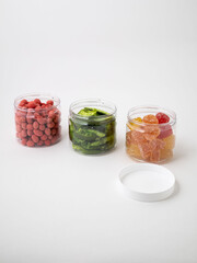 Collection of three gummy jelly colourful jars of different sizes on transparent background