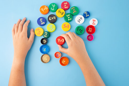 Learn the multiplication tables in an interactive way, free math multiplication learning games for 2rd, 3th grade. bottle caps with multiplication exercises on blue background, practice for kids