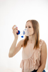 Woman using a respiratory inhaler.