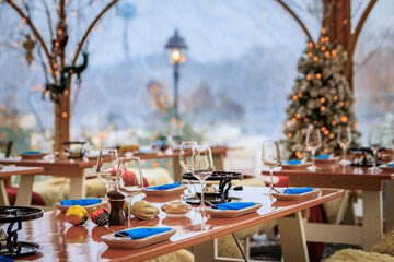 Rustic winter wonderland: wooden tables, cozy fur throws, Christmas trees and festive touches await diners at a restaurant in Zurich, Switzerland