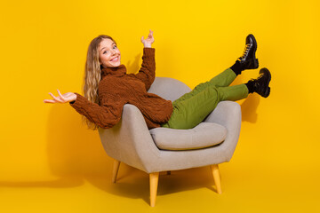 Full body profile portrait of nice young girl sit chair isolated on yellow color background
