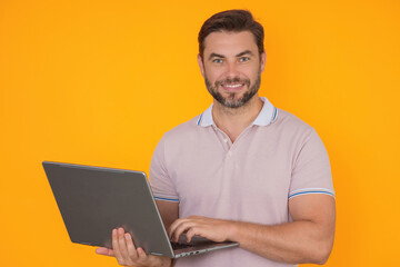 Man using laptop. Man worker watch video on computer laptop. Serious man hold laptop computer. Caucasian man in glasses work with laptop, studio isolated portrait.