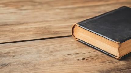 Explore the charm of an antique leatherbound book, beautifully weathered, on a rustic table. A...