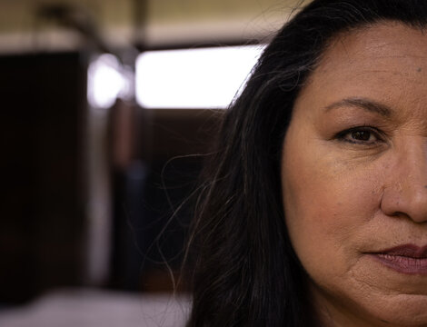 Close-up of mature senior woman with thoughtful expression at home, copy space