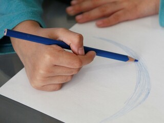 hand of a girl coloring for school