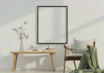 A minimalist living room with a wooden chair, table and a framed poster.  A vase with dried flowers is on the table. Sunlight is streaming through the window
