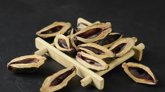 dried betel nuts snack on black background.