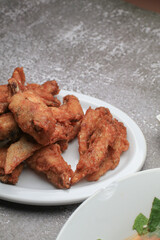 Deep Fried chicken wings with sweet sauce on white plate. Appetizer asian food. Advertising for business entities or brands.  