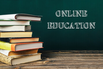 A stack of books with the word online education written on top