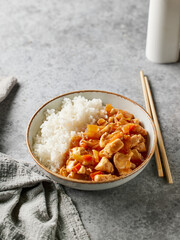bowl of boiled rice with sweet and sour sauce
