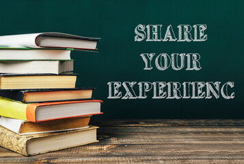 Stack of books with the words share your experience written on top