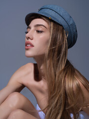 Seductive woman face. Sensual young woman posing in fashion cap hat. Beautiful sexy model. Beauty face. Sensual girl, sexy model portrait. Natural beauty.