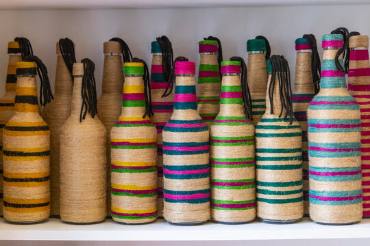 Yasmine Hammamet, Nabeul, Tunisia. Bottles decorated with colored string at a artisan crafts market.