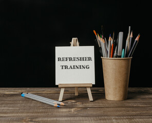 A white board with the word refresher training written on it