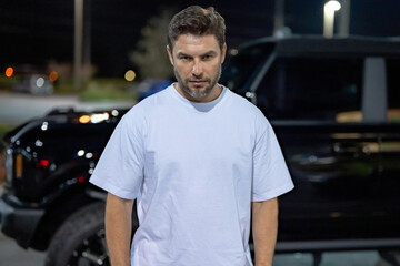 Gangster man. Dangerous angry man near car on night urban street. Dangerous aggressive man. Criminal city. Danger american district. Aggressive angry man outdoor. Danger naght city.