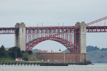 Red suspension bridge spans bay with stunning architectural view and cityscape