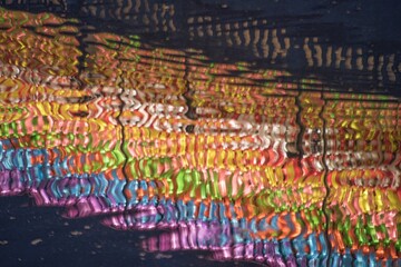 Colorful LED lights column reflection on a canal in Loy Krathong festival (Thailand)