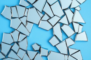 model modern photography and avant-garde, A collection of fragmented mirror pieces scattered across a vibrant blue surface, reflecting light and creating an abstract design.