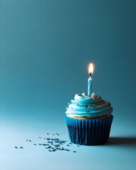 Single Blue birthday cupcake with a lit candle.