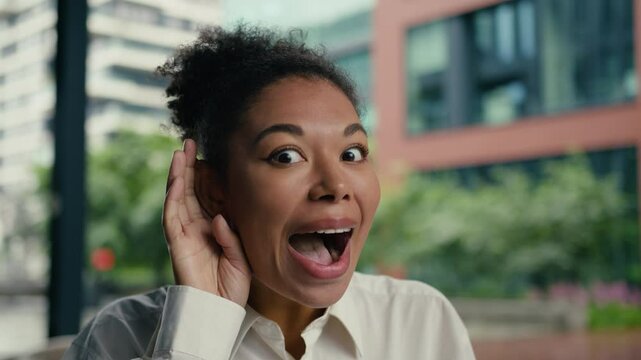 Face African American eavesdrop gossip news excited woman female girl businesswoman listen emotions holding hand near ear overhearing amazed rumors secret friend ethnic hearing business city outside